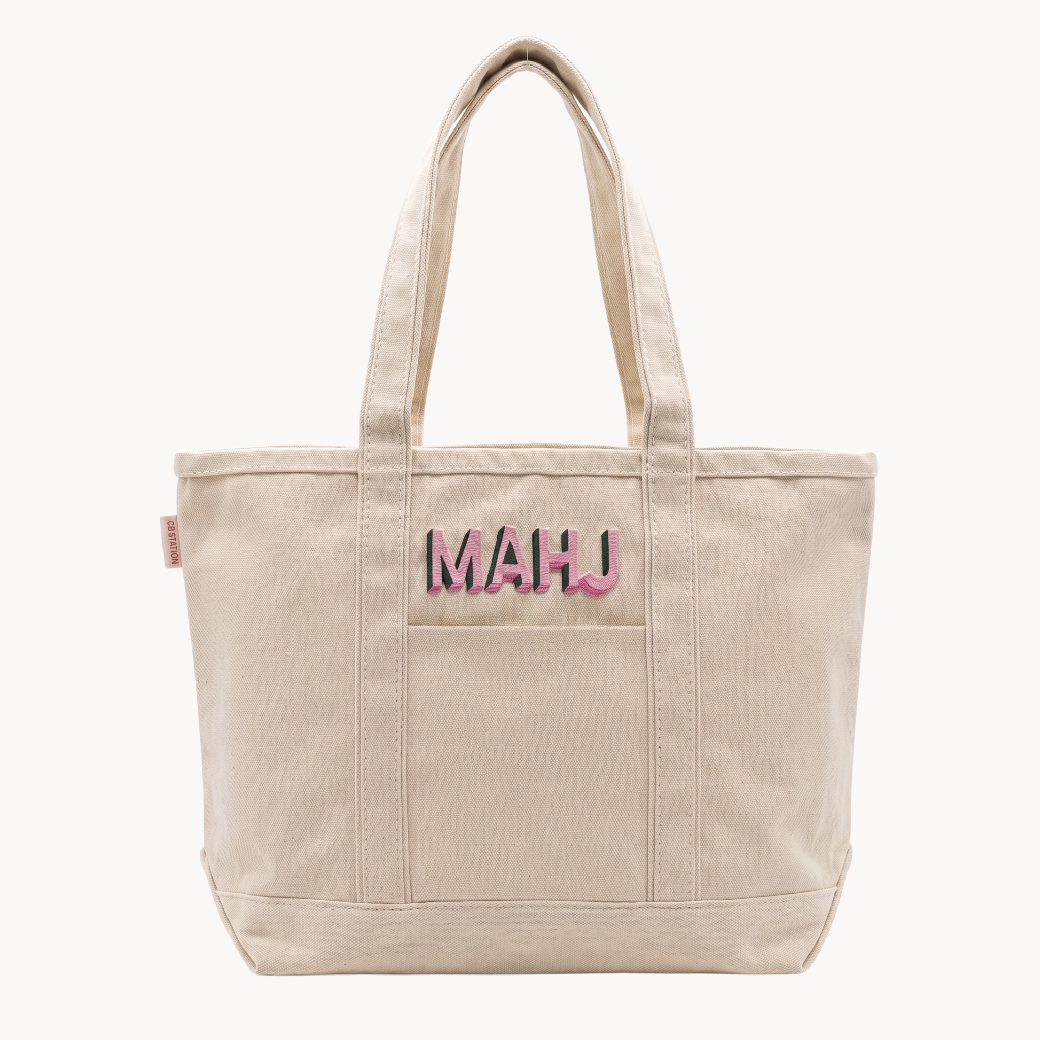 Canvas tote bag with embroidered “MAHJ” lettering in pink and green, designed for carrying mahjong tiles and accessories